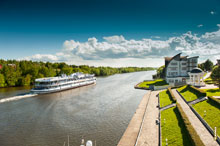 Фото уходящего по Москва-реке теплохода и территории ресторанно-гостиничного комплекса «Белый берег»