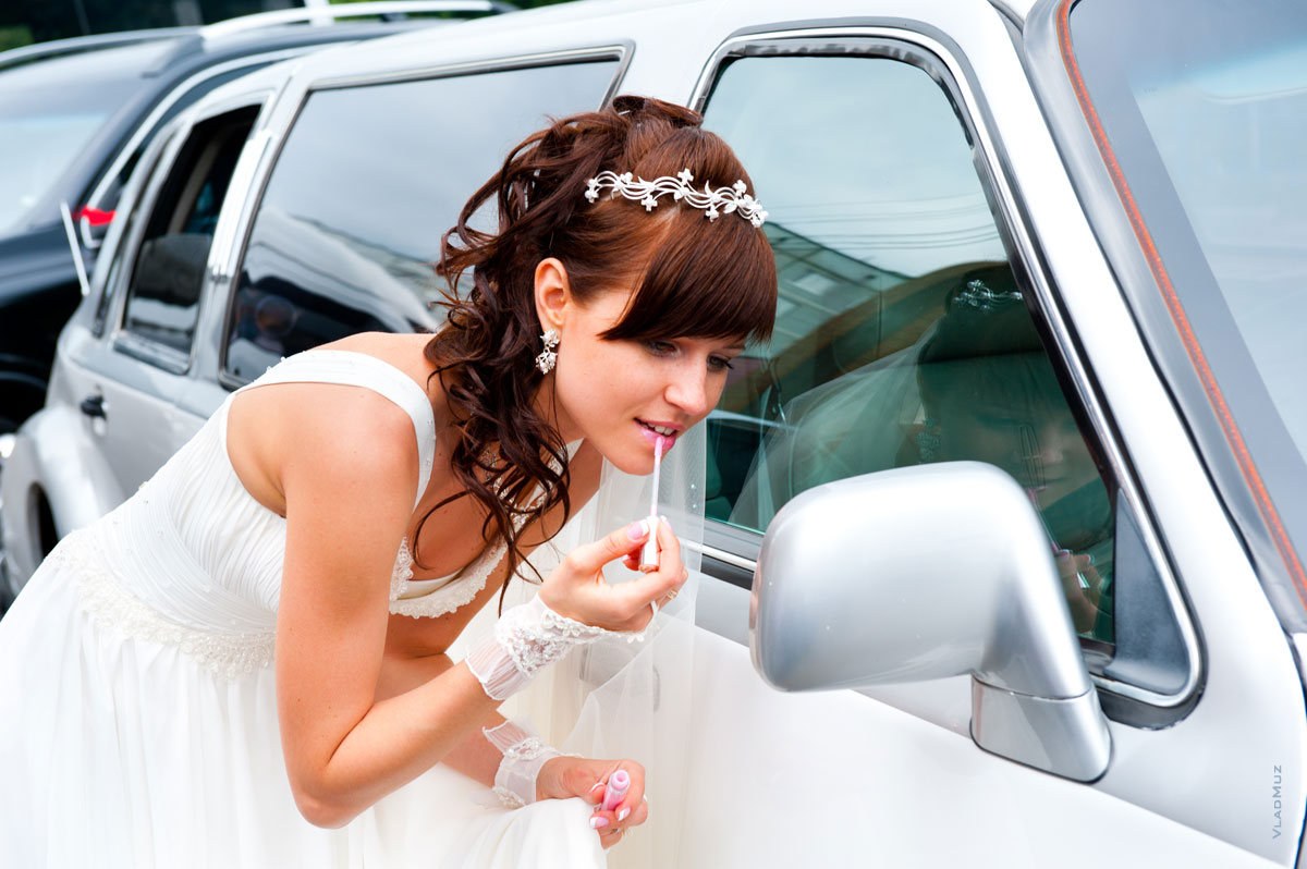 Фото невесты перед зеркальцем свадебного лимузина