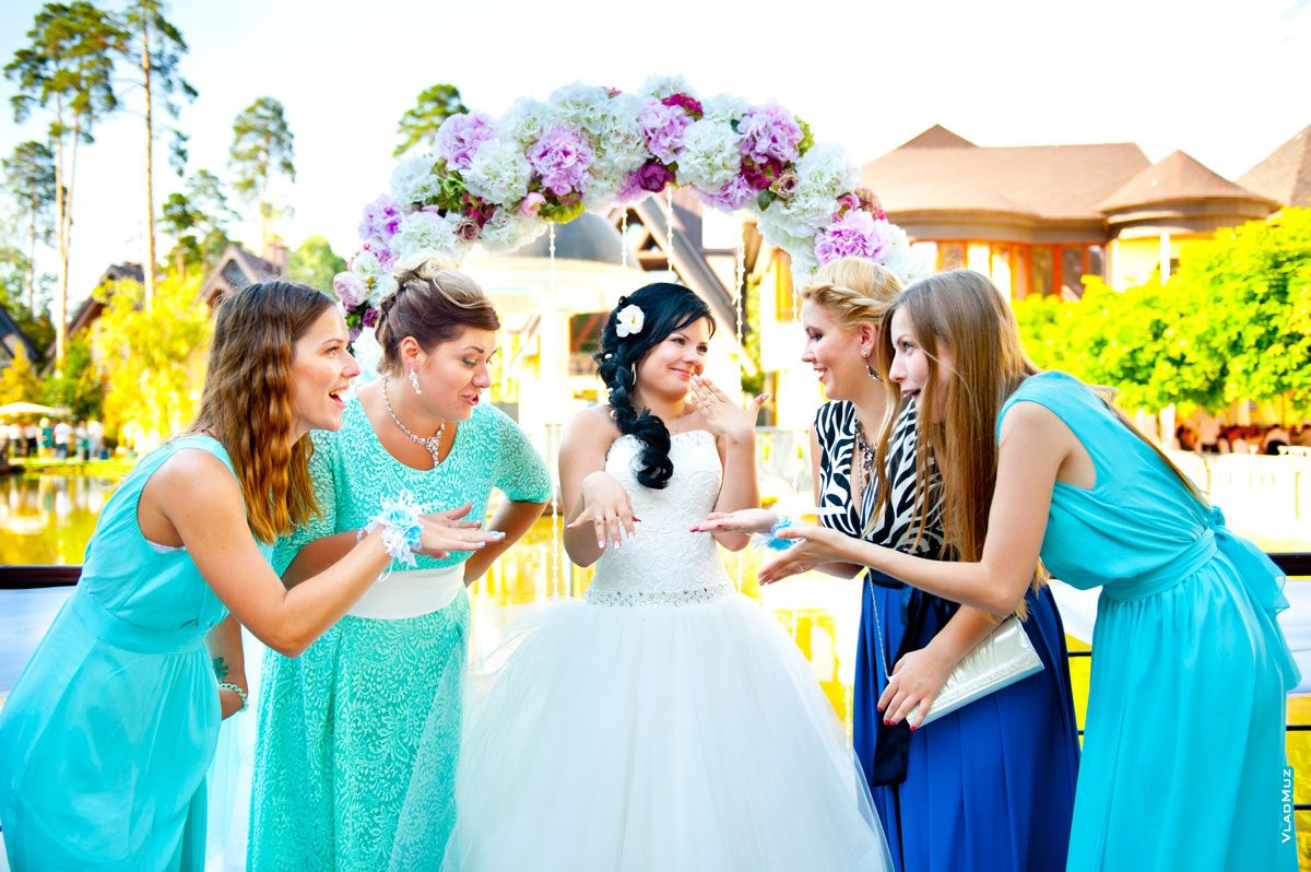 Фото невесты, показывающей обручальное кольцо, и подруг невесты рядом