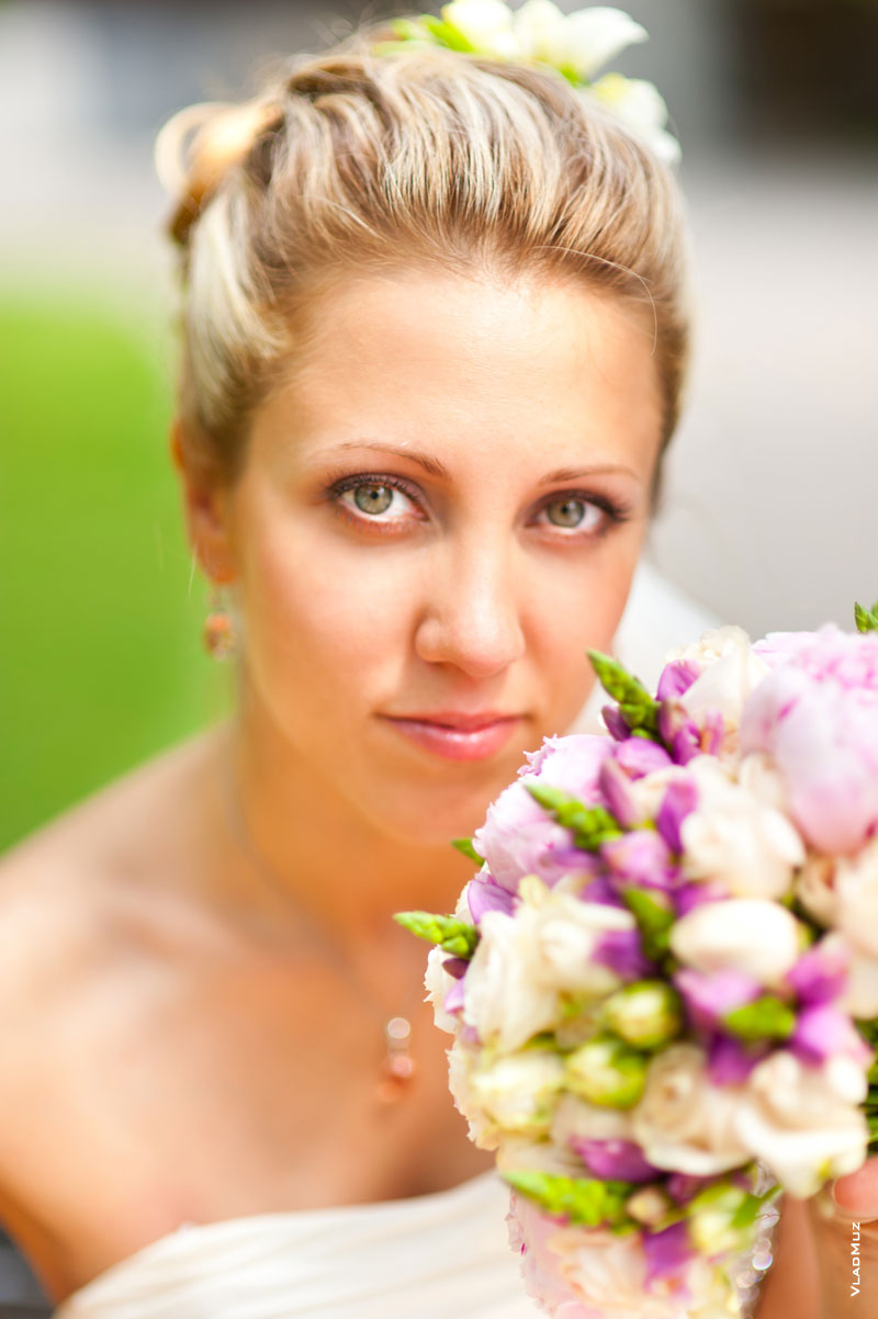 Красивый фотопортрет невесты с букетом с избирательной резкостью на глазах