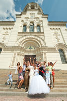 Живое свадебное групповое фото на ступенях на фоне Вознесенского собора