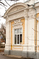 Полуколонны, пилястры, барельефы, лепнина на фасаде старинного дома крупным планом