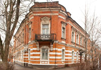 Красивый 2-х этажный старинный дом с балконом и декоративным треугольным фронтоном над окном