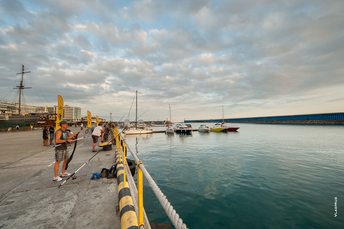 Фото рыбаков на берегу и яхт с лодками на стоянке в яхтенном порту Адлера «Имеретинский»